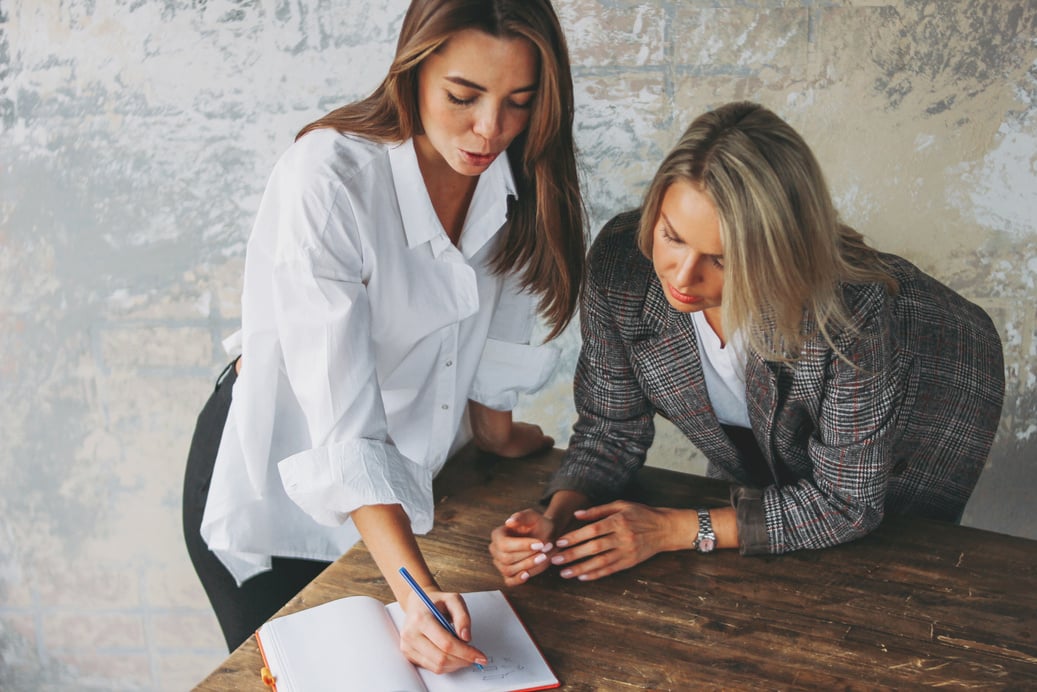 Young Woman Coaching Colleague in the Office